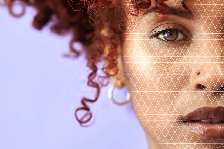 Half of the face of a young Black woman with red, curly hair.