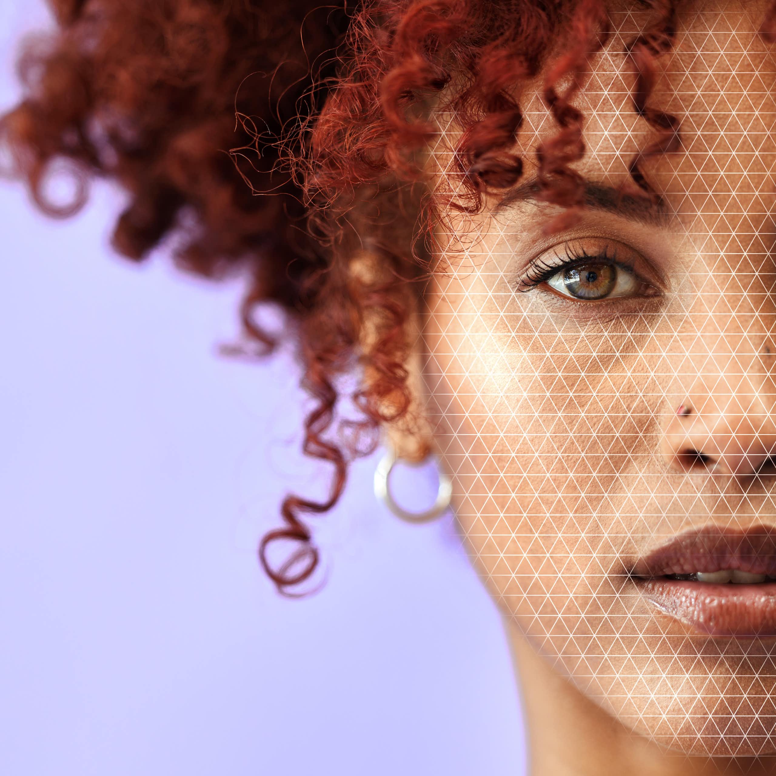 Half of the face of a young Black woman with red, curly hair.