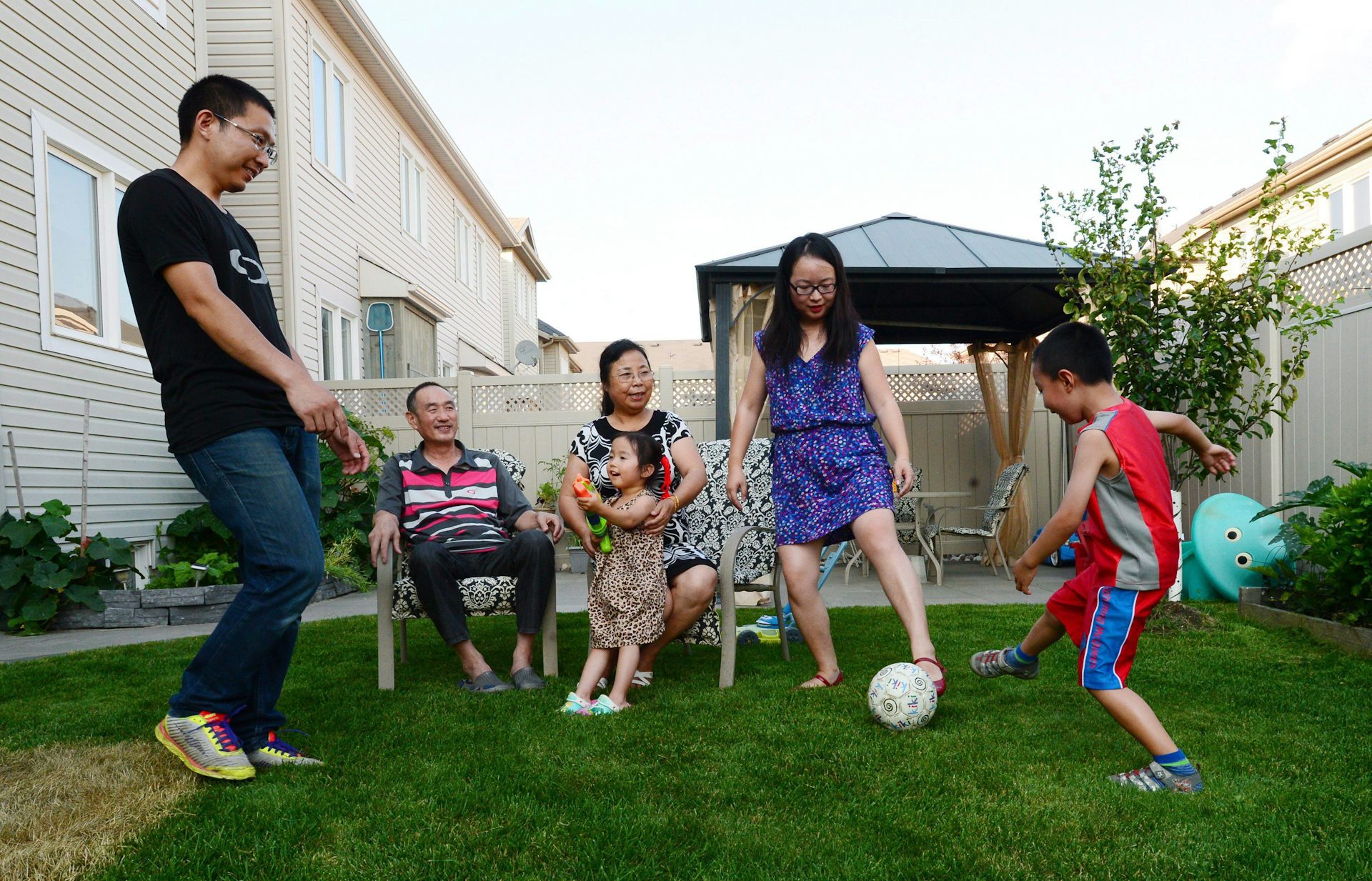 La familia juega al fútbol en el patio, mientras que la abuela y el abuelo cayeron.