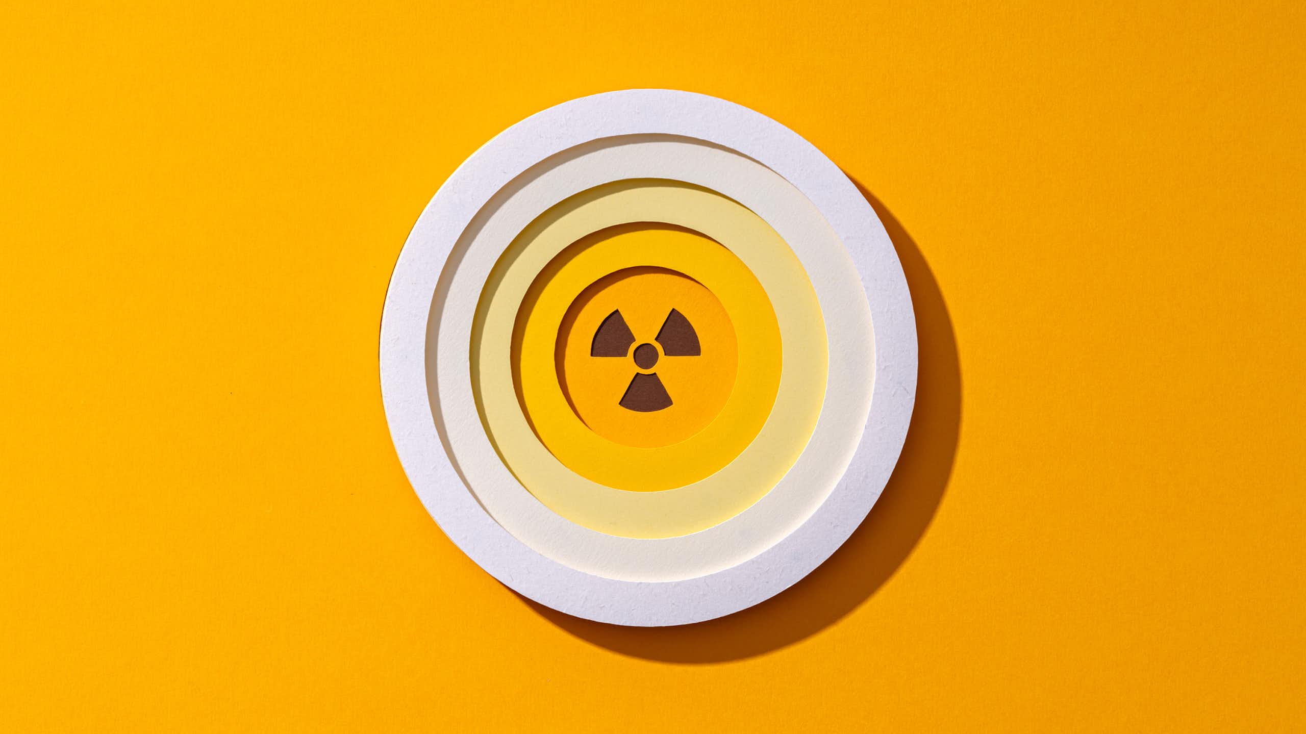 A bright radiation symbol in a circle. It is three triangles coming off of a center circle, equally spaced apart.