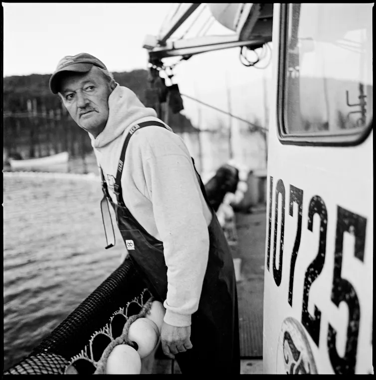 a fisherman standing a boat
