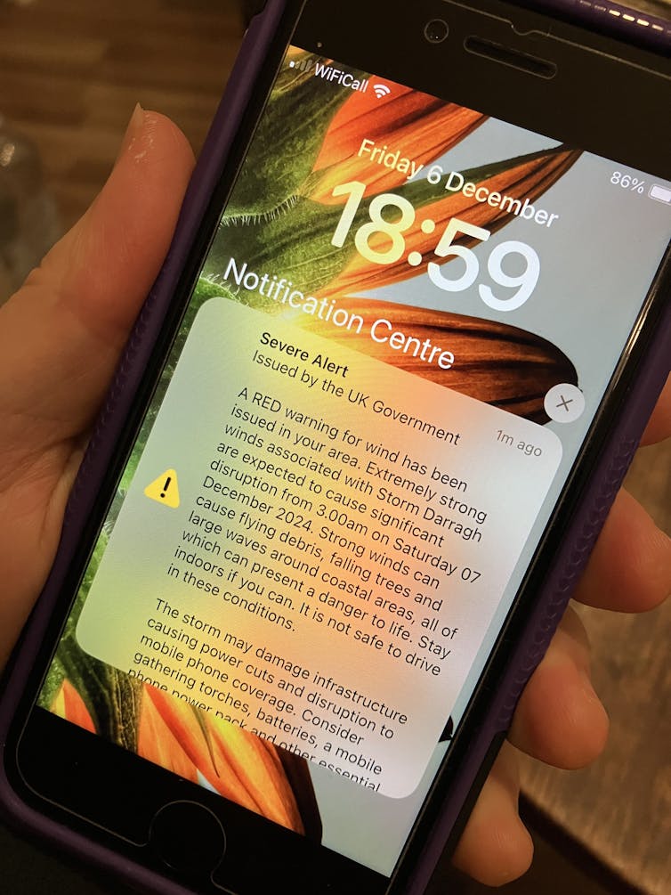 mobile phone screen showing red weather warning for high winds.