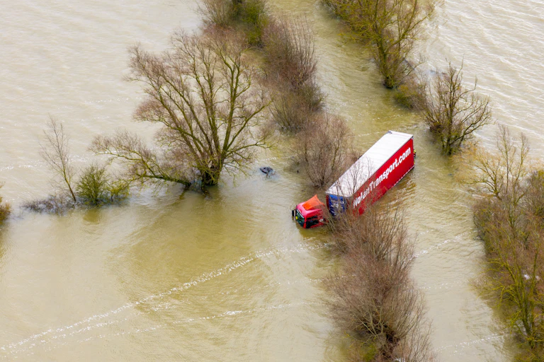 jack-knifed lorry stranded in flood water