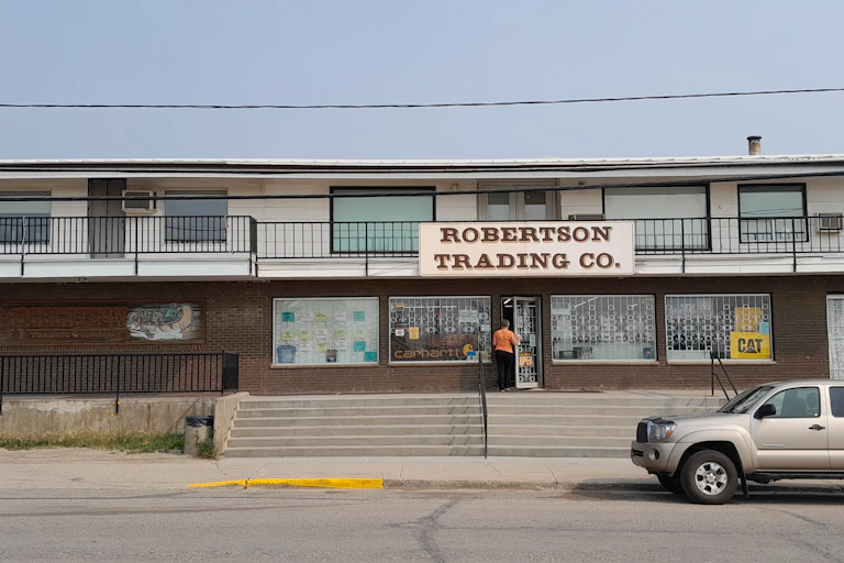 a small two-storey building with a sign reading Robertson trading co.