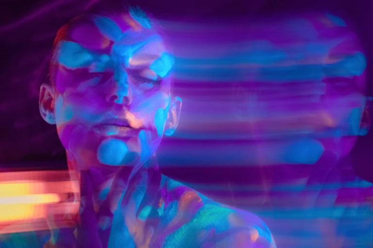 Psychedelic concept, person's head and shoulders, with lines of light fading to right