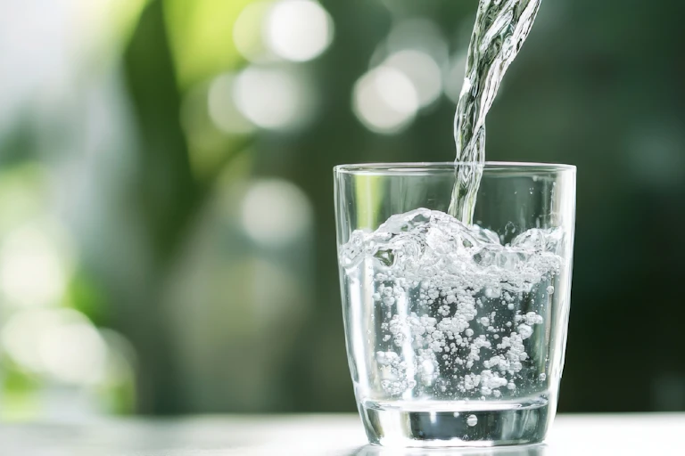 Glass of water on a table.