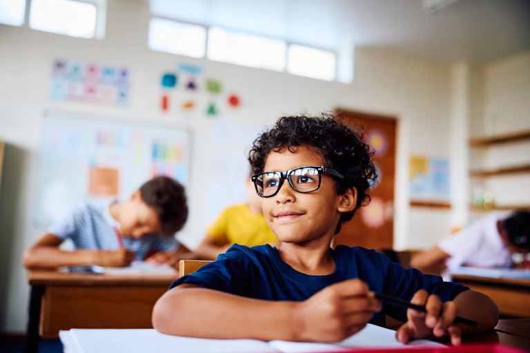 A boy in a classroom.