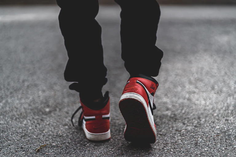 Close up of feet walking in red and white trainers