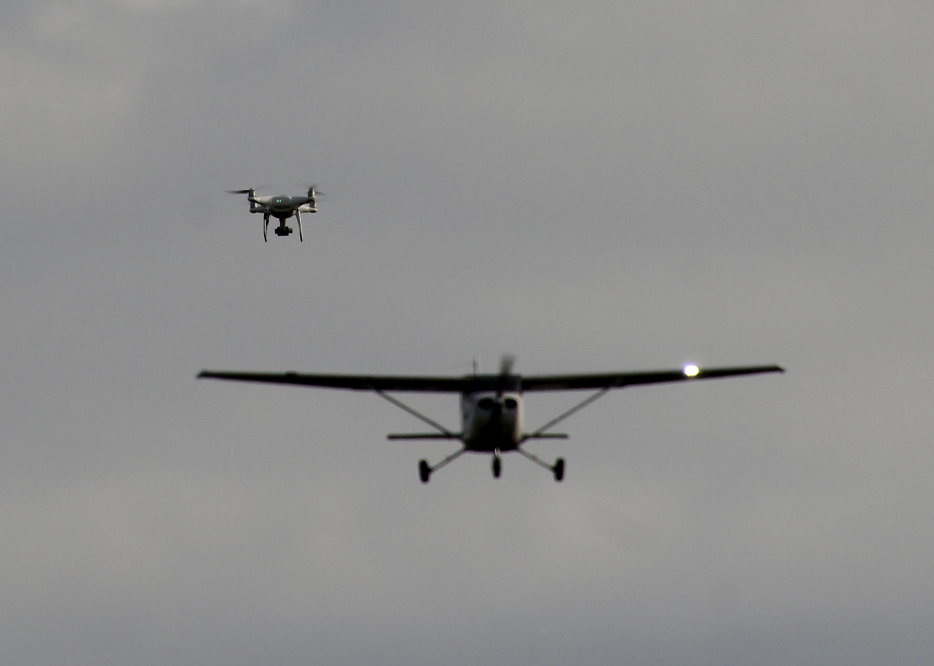 A drone and a small airplane in the air near each other