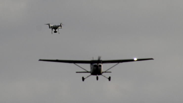 A drone and a small airplane in the air near each other