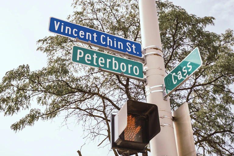 A street sign reads "Vincent Chin St." "Peterboro" and "Cass"
