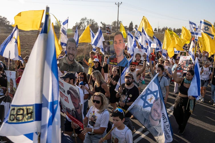 No finish to the violence as Israel launches its attack on Gaza Town 1 Large demonstration of Israeli citizens carrying flags and banners with photographs of hostages.