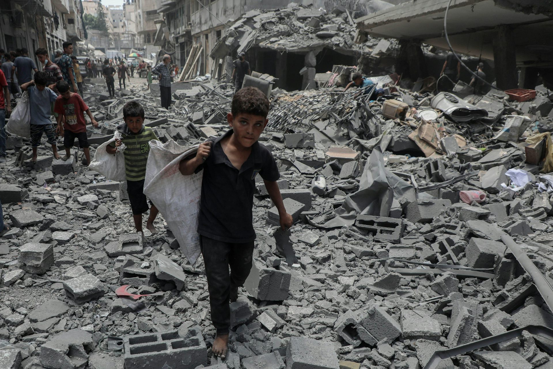 Children walking in the rubble left by an Israeli airstrike on Gaza City, August 19 2025.