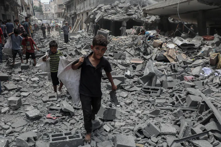 No end to the violence as Israel launches its assault on Gaza City 1 Children walking in the rubble left by an Israeli airstrike on Gaza City, August 19 2025.