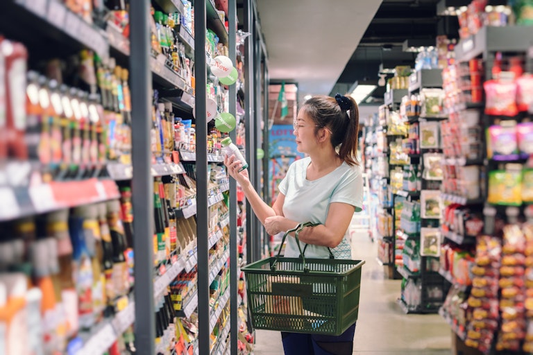 Woman looks at food label