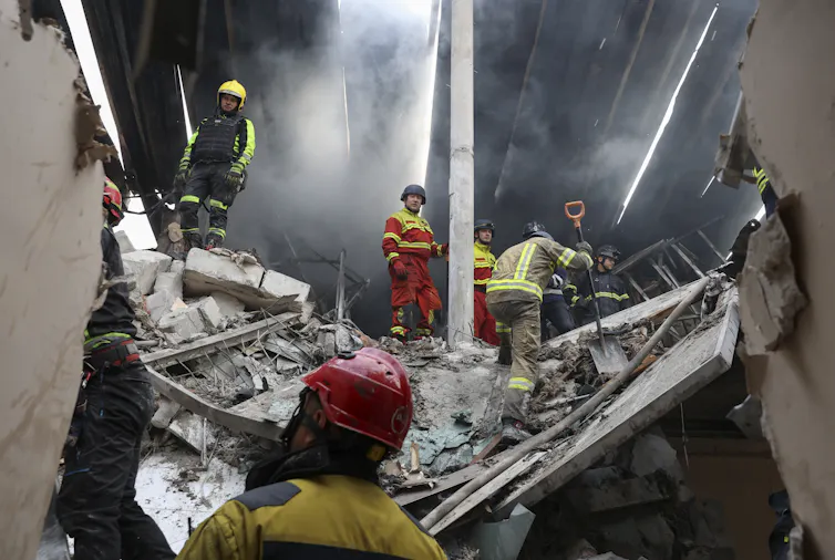Ukrainian rescue workers at the site of a drone strike.