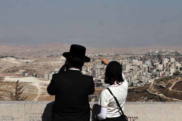 Israelis overlook a settlement in the West Bank.