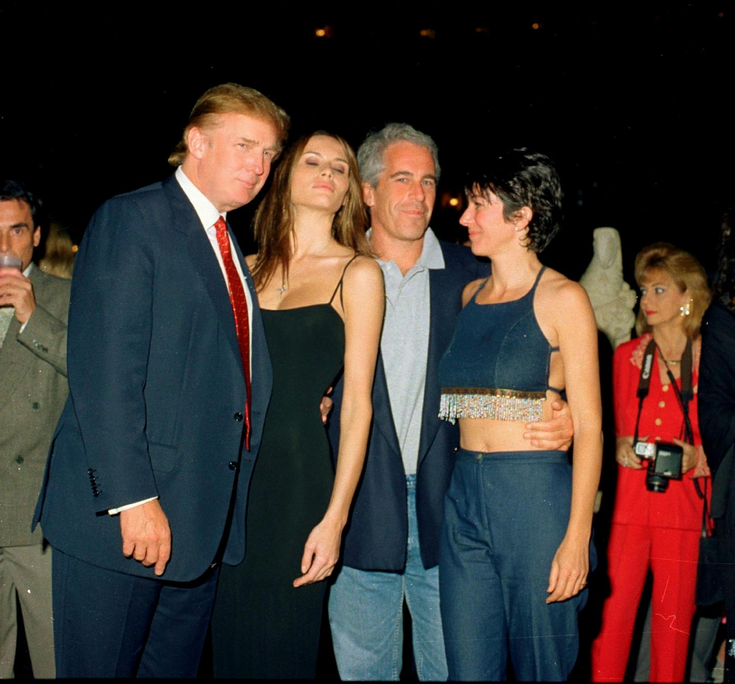 Two men and two women pose at a party.