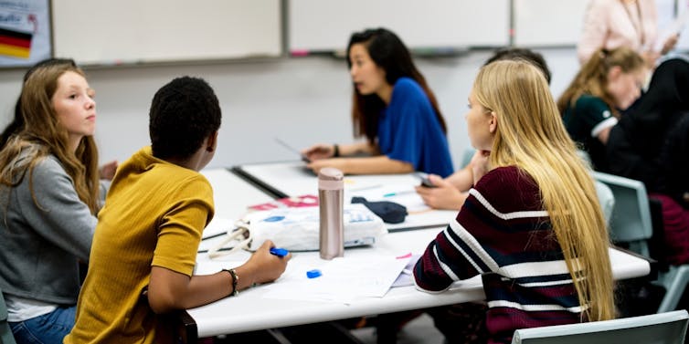 Students round a table
