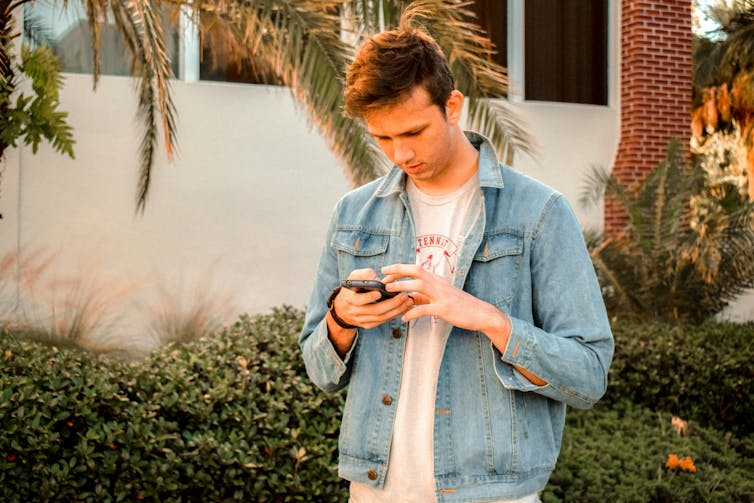 a man looks at his smartphone