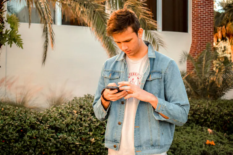 a man looks at his smartphone