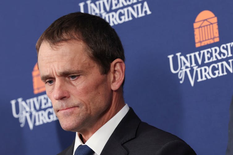 Middle-aged man with short, brown hair, wearing a suit and tie.