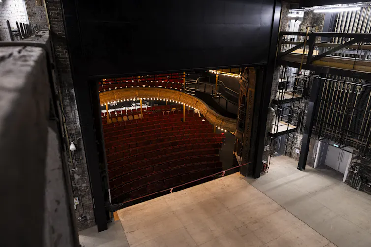 A stage inside a modern theatre with the Victorian auditorium in front.