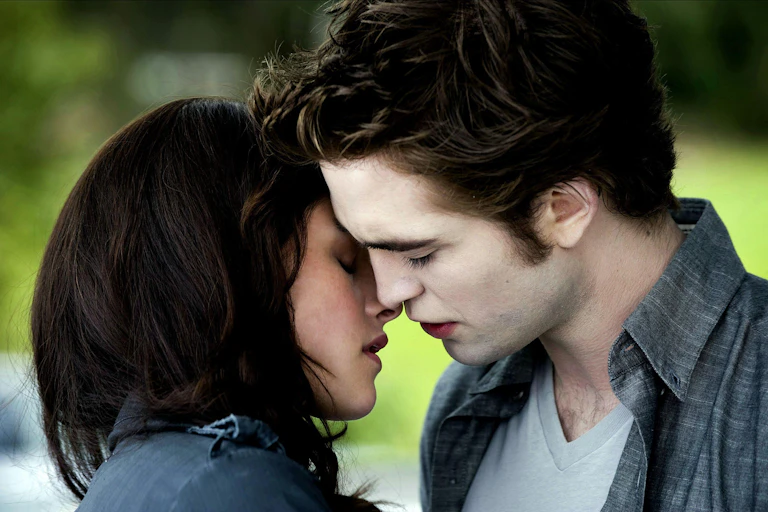 Bella Swan and Edward Cullen lean in for a kiss.