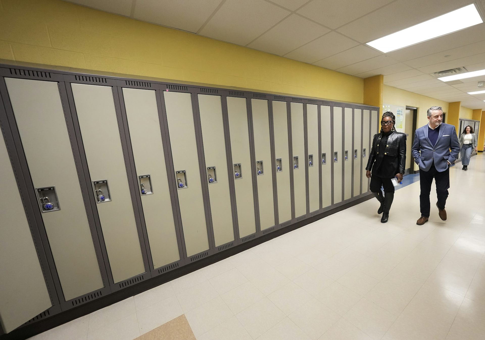 Los dos adultos vieron el despertar del pasillo de la escuela con armarios.