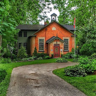 A brick building with Canadian flag out front.