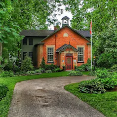 A brick building with Canadian flag out front.