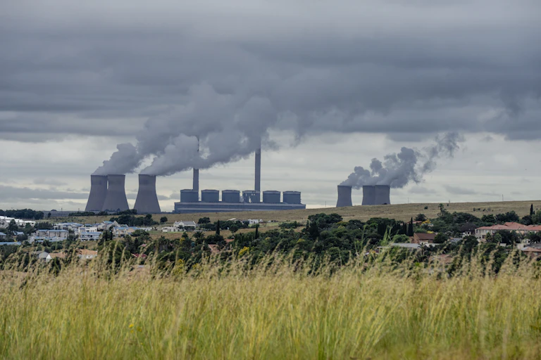 Large building and cooling towers with vapour rising from them