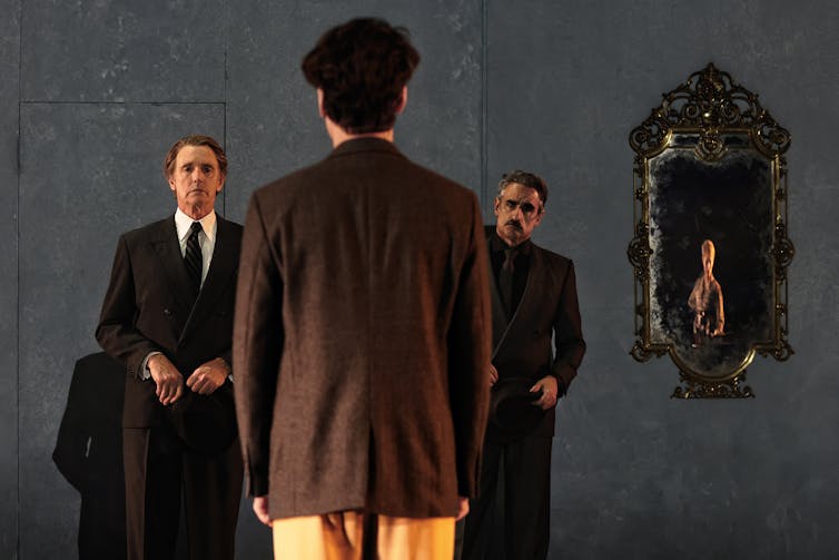 Three men on stage.