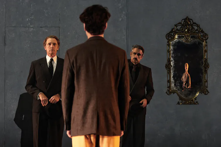 Three men on stage.