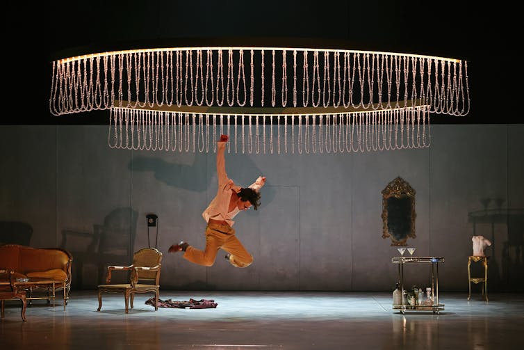 A man leaps on stage.