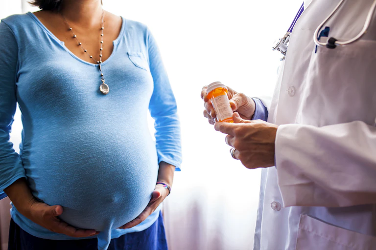 Headless doctor holds pill bottle while talking with headless patient