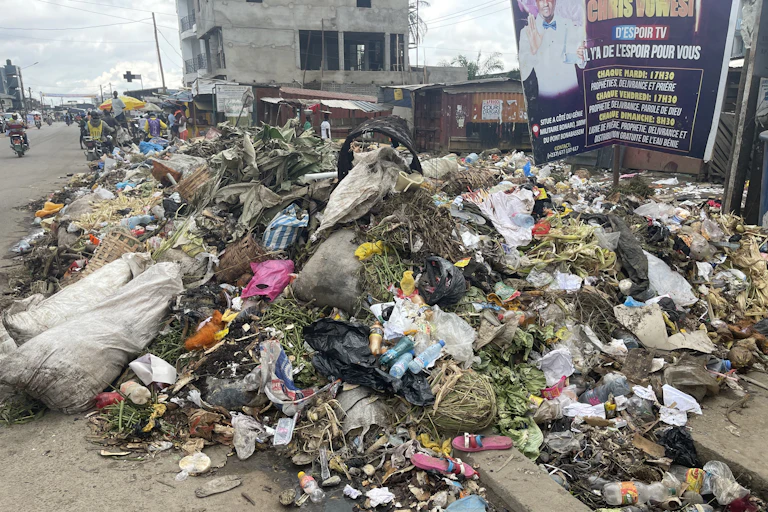 Garbage in a pile on the side of the road