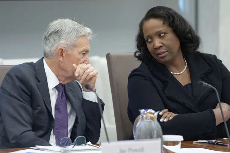 A man and a woman sit and chat.