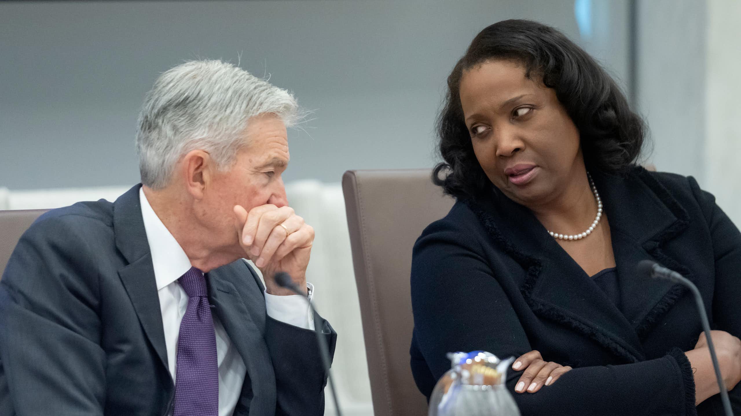 A man and a woman sit and chat.