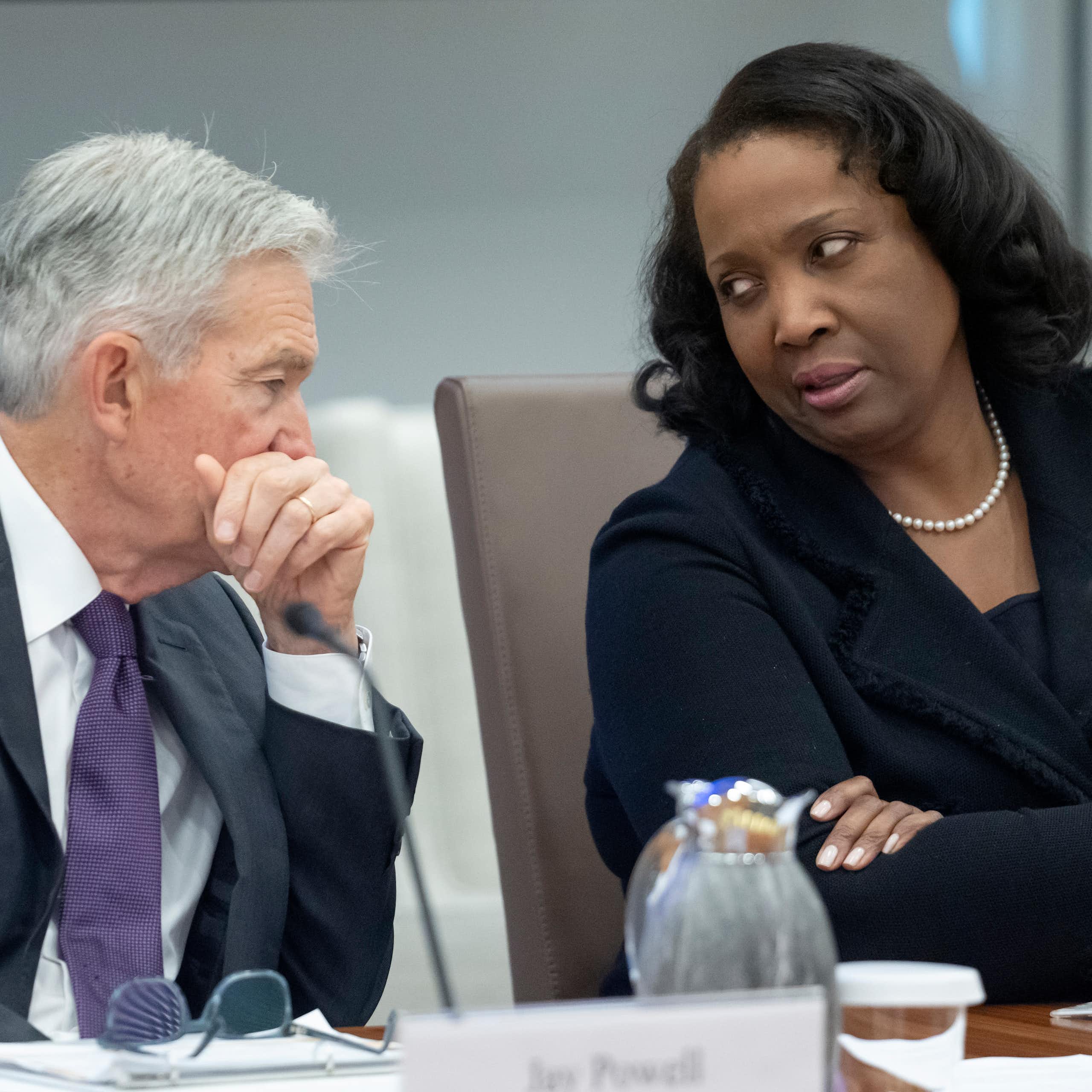 A man and a woman sit and chat.