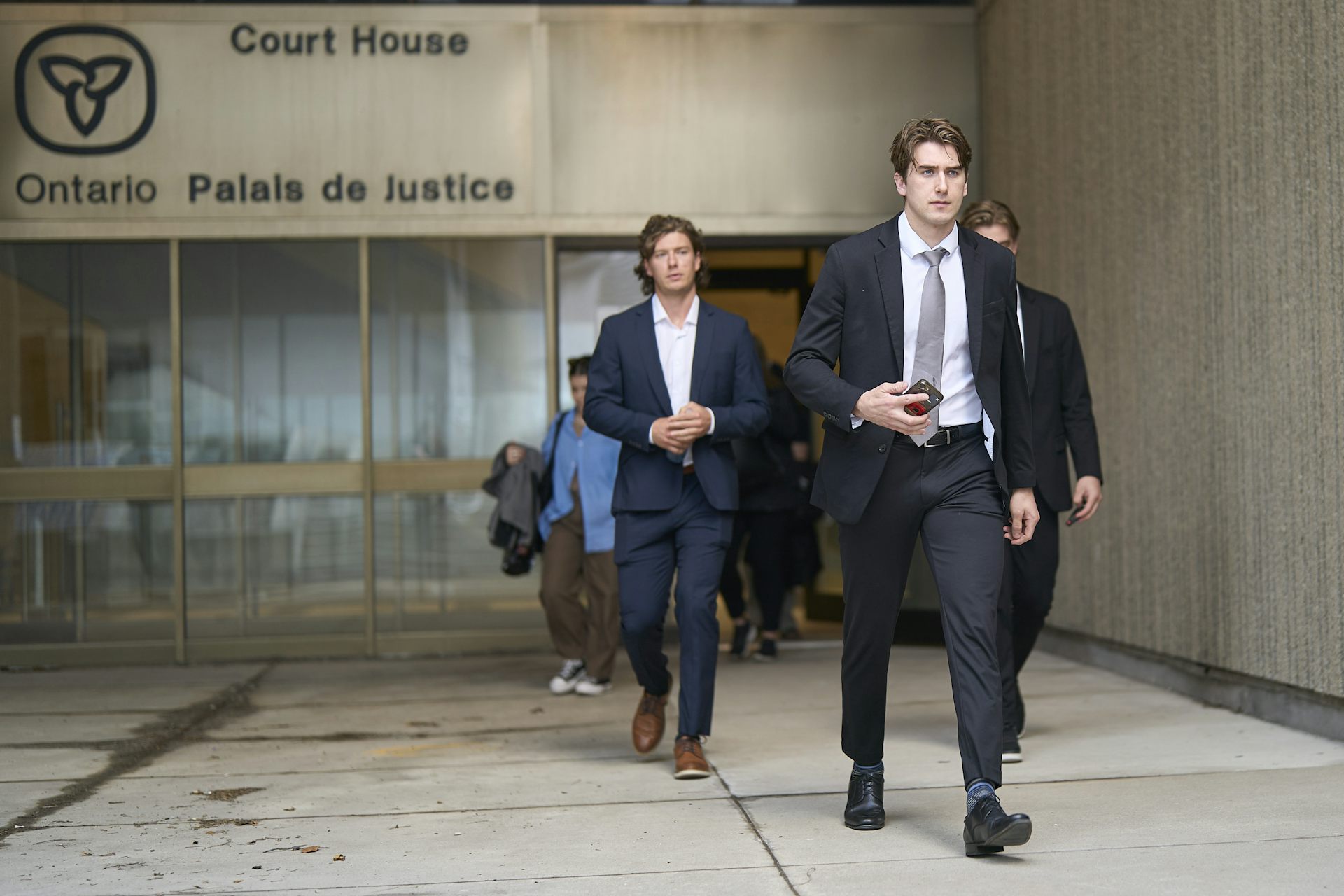 El hombre vestido con un traje incorporado sale de Londres, Ontario Courtroom.