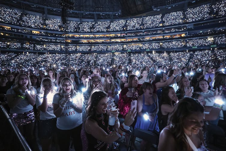 A full stadium of fans, mostly young women.