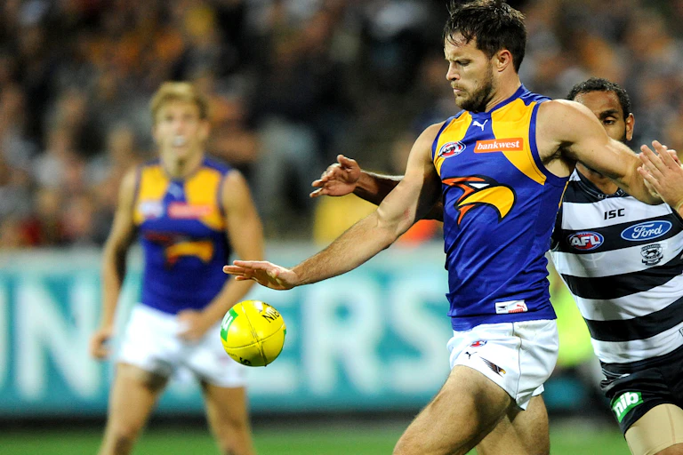 Mitch Brown of West Coast gets a kick away against Geelong in 2014.