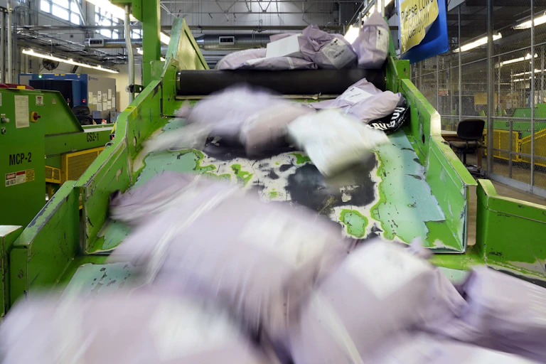 Parcels slide down a ramp after being scanned at the US Customs and Border Protection overseas mail inspection facility at Chicago's O'Hare International Airport.