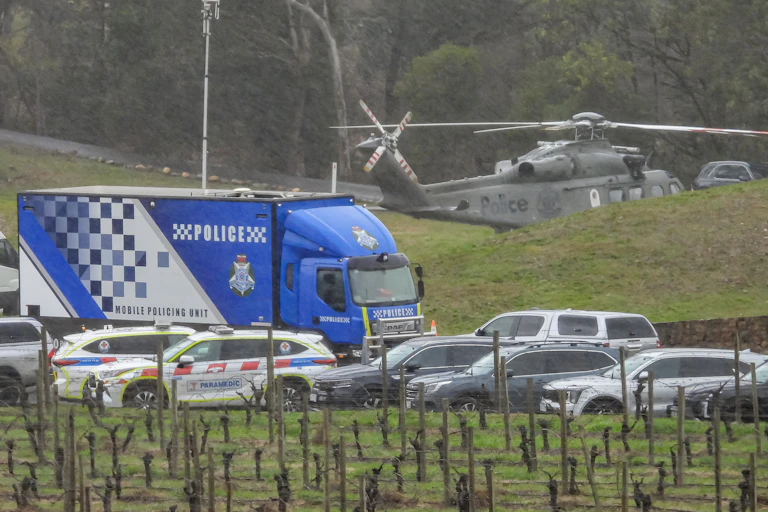 A large contingent of Victorian Police and vehicles are seen in Porepunkah, Victoria.