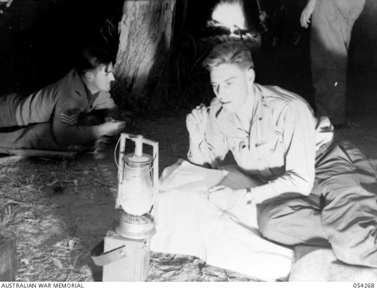 Under the light of a hurricane lamp.