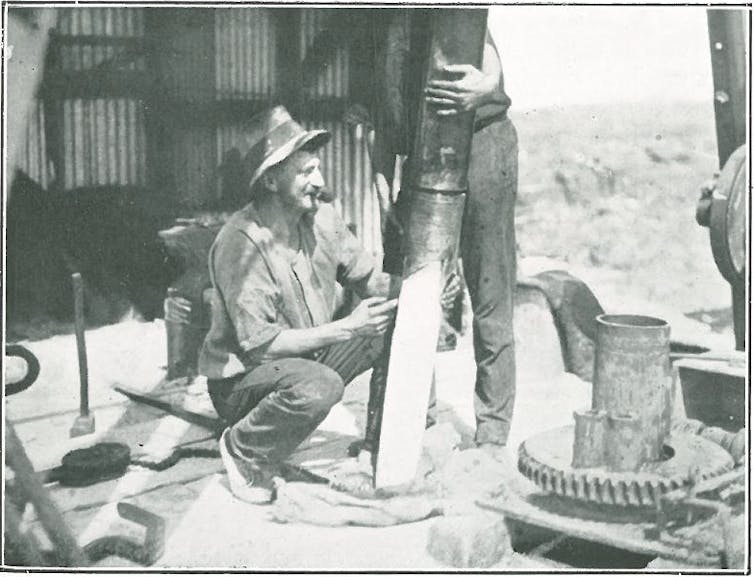 man with drilling equipment on boat with coral core drilled from reef.