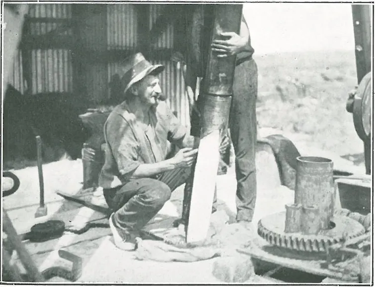 man with drilling equipment on boat with coral core drilled from reef.