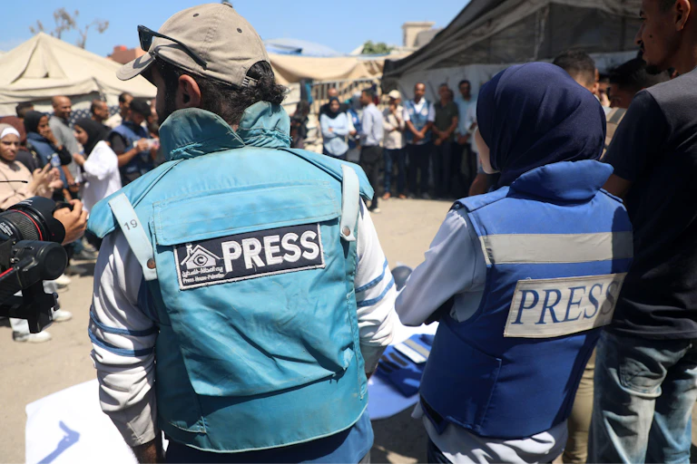 People wearing press insignia at the site of the Nasser hospital strike on August 25 2025.