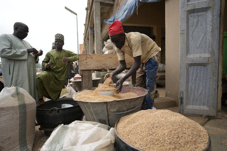 A man sells grain in Dawanau International Market in Kano, Nigeria on July 14, 2023.